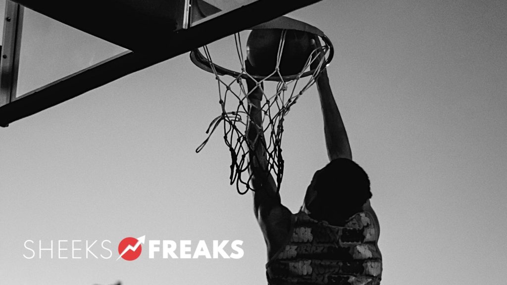 Black and white image of a person dunking a basketball with a logo in the bottom left corner that says "Sheeks Freaks"