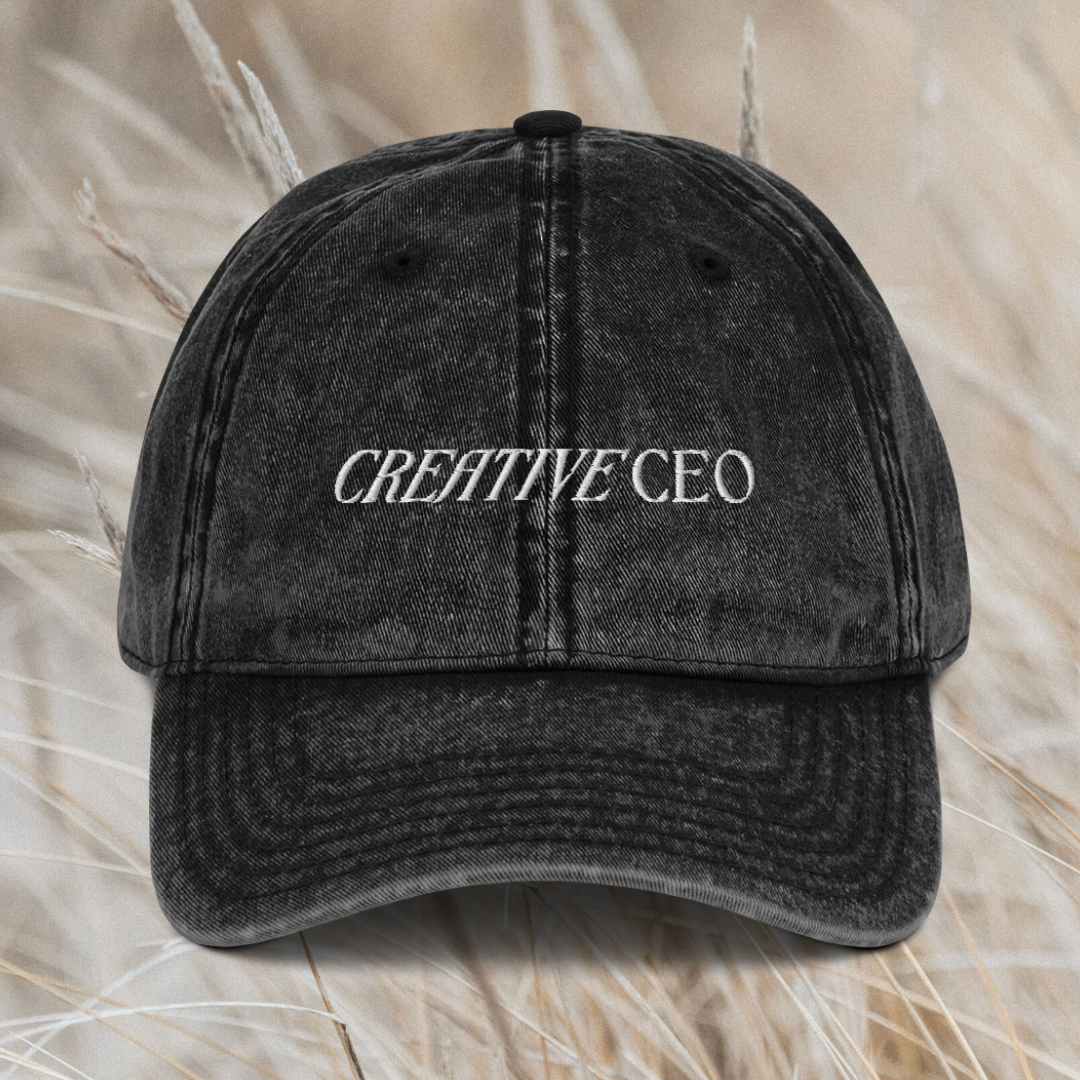 Grey hat sitting on a sheet with white text on it that says "Creative CEO".