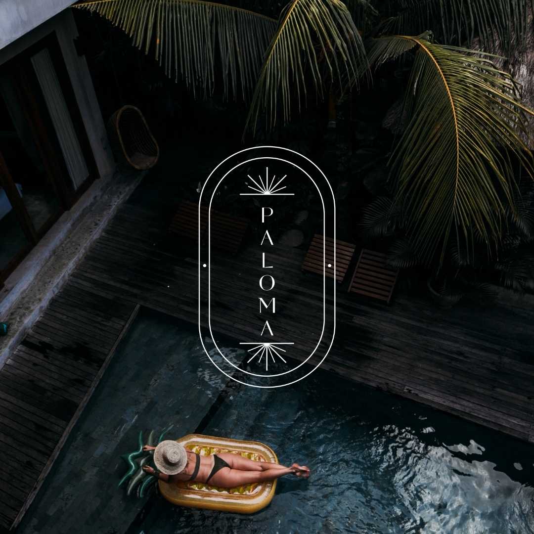 Overhead image of a woman floating in a luxury pool with a logo in the middle for "Paloma".