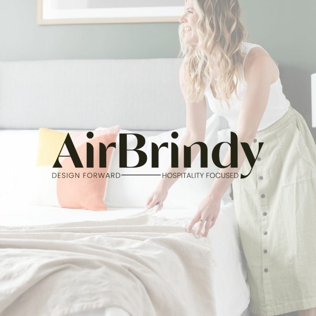 Woman making a bed with a white overlay over the image. In the middle is a logo that reads "AirBrindy. Design Forward - Hospitality Focused".