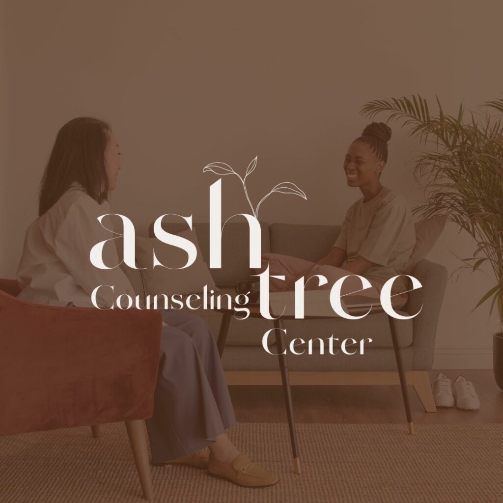 Two people sitting across from each other on couches with a red overlay over the image. On top is a logo that says "Ash Tree Counseling Center".
