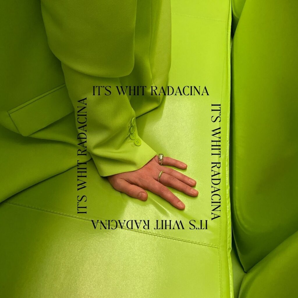Image of a person in a bright green suit sitting on a bright green couch. In the middle are the words "It's Whit Radacina" repeated in a square.