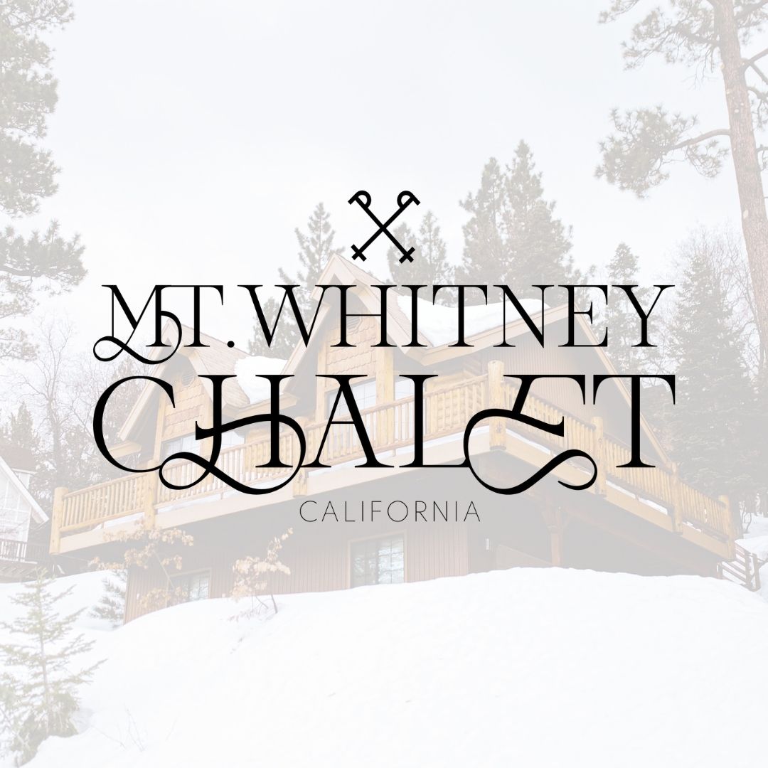 Image looking up at a ski chalet with a white overlay over the image. On top of the image is a black logo that reads "Mt. Whitney Chalet, California".