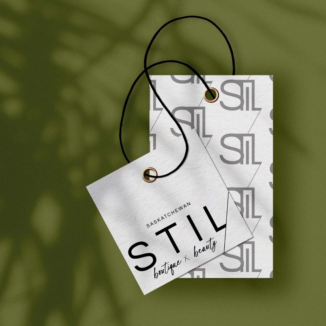 Clothing tags for "Stil boutique x beauty" on an olive green background.
