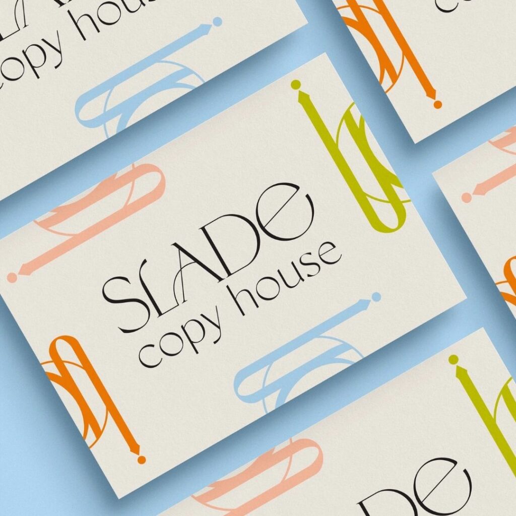 Business cards in an even grid with a logo in the middle that says "Slade Copy House"