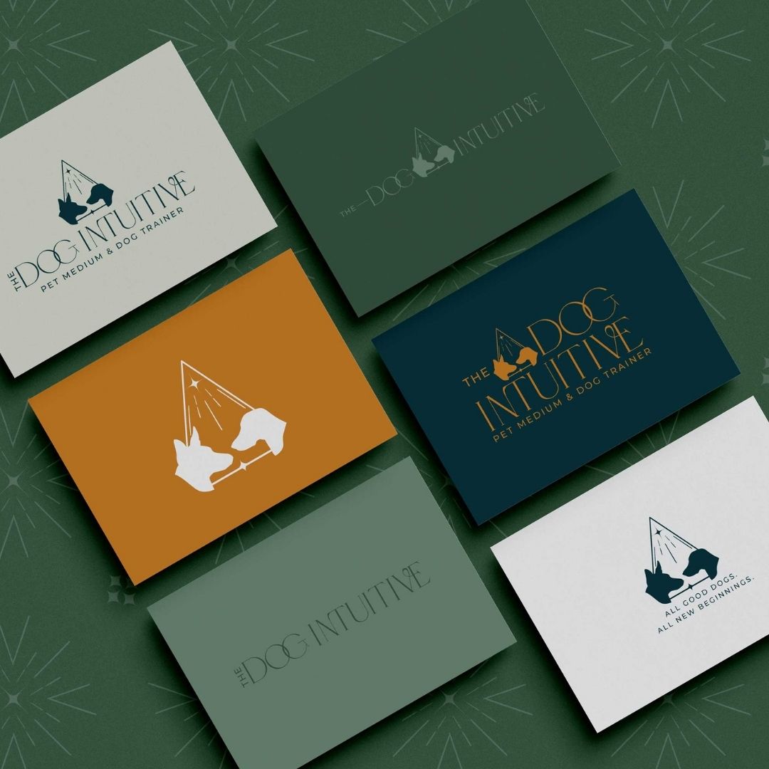 Six business cards in various colors with logo and icons for "The Dog Intuitive" on them.