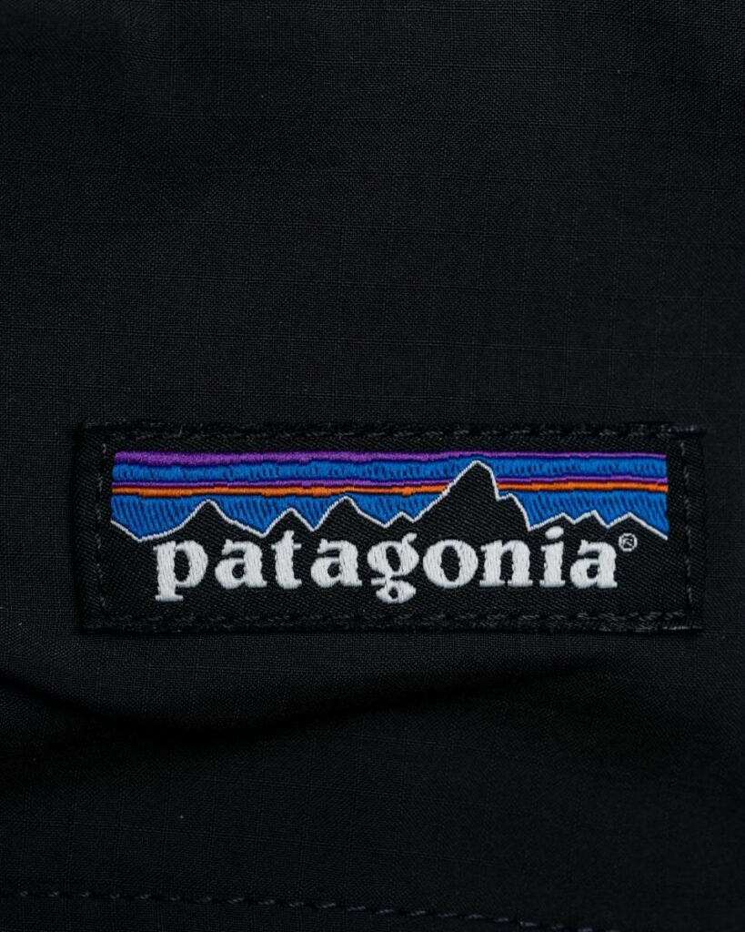 Black jacket with a logo patch on it that says "Patagonia". 