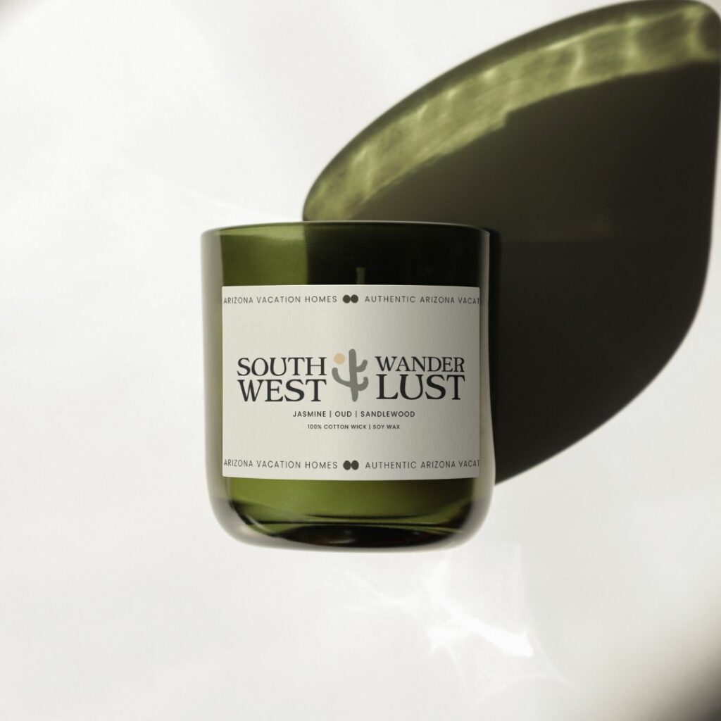 A candle with a label on it that has a logo for Southwest Wanderlust on it.