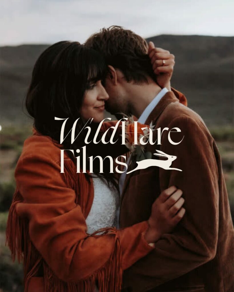 Couple hugging intimately with a logo on top that says "Wild Hare Films" with an icon of a hare jumping next to it. 