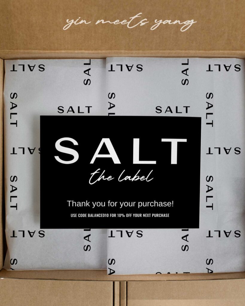 A box has a thank you card and branding for SALT - The Label.