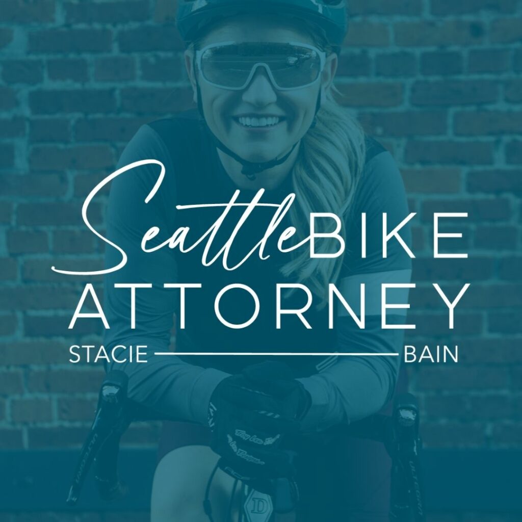 Seattle Bike Attorney, a bike accident lawyer brand, with a smiling cyclist in gear and helmet, superimposed with the brand name and 'Stacie Bain' in white script against a blue overlay.