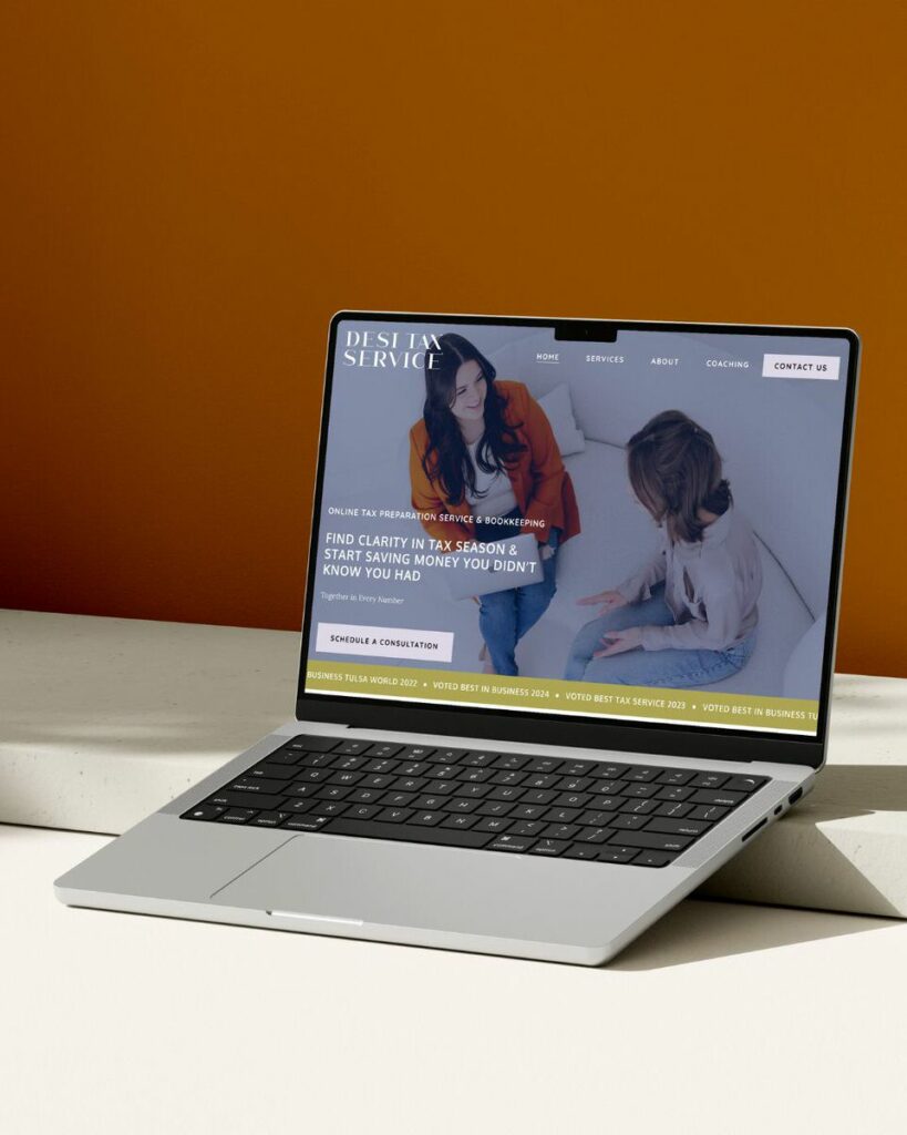 A laptop on an orange background showcasing the "Desi Tax Service" website with a banner that reads "Find clarity in tax season & start saving money you didn’t know you had" and an image of two women reviewing documents.