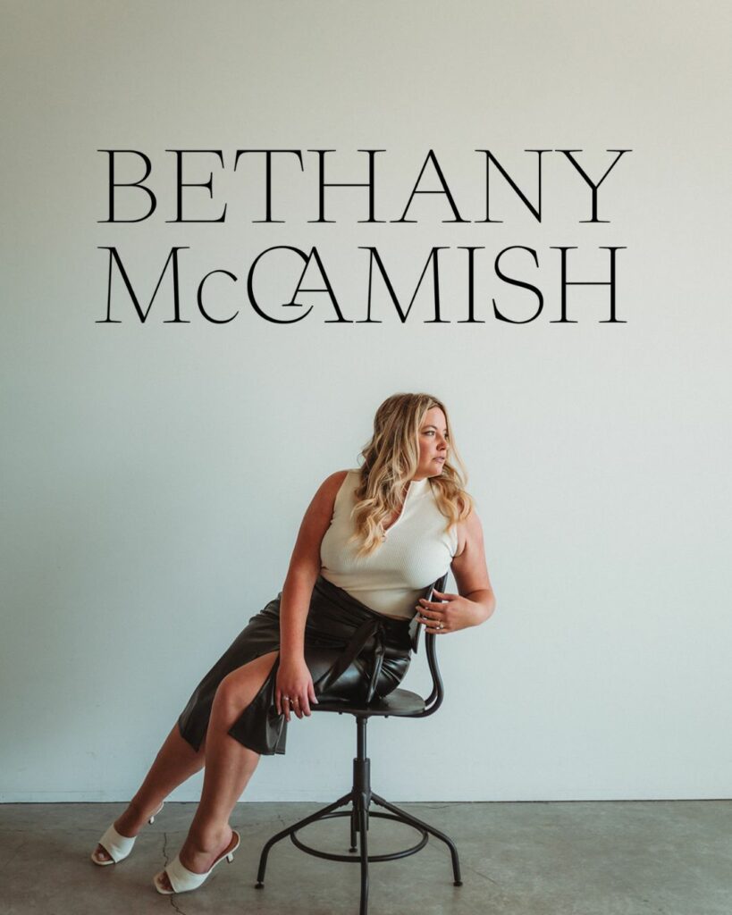 A woman sitting on a chair looking off to the side with a logo on top for Bethany McCamish