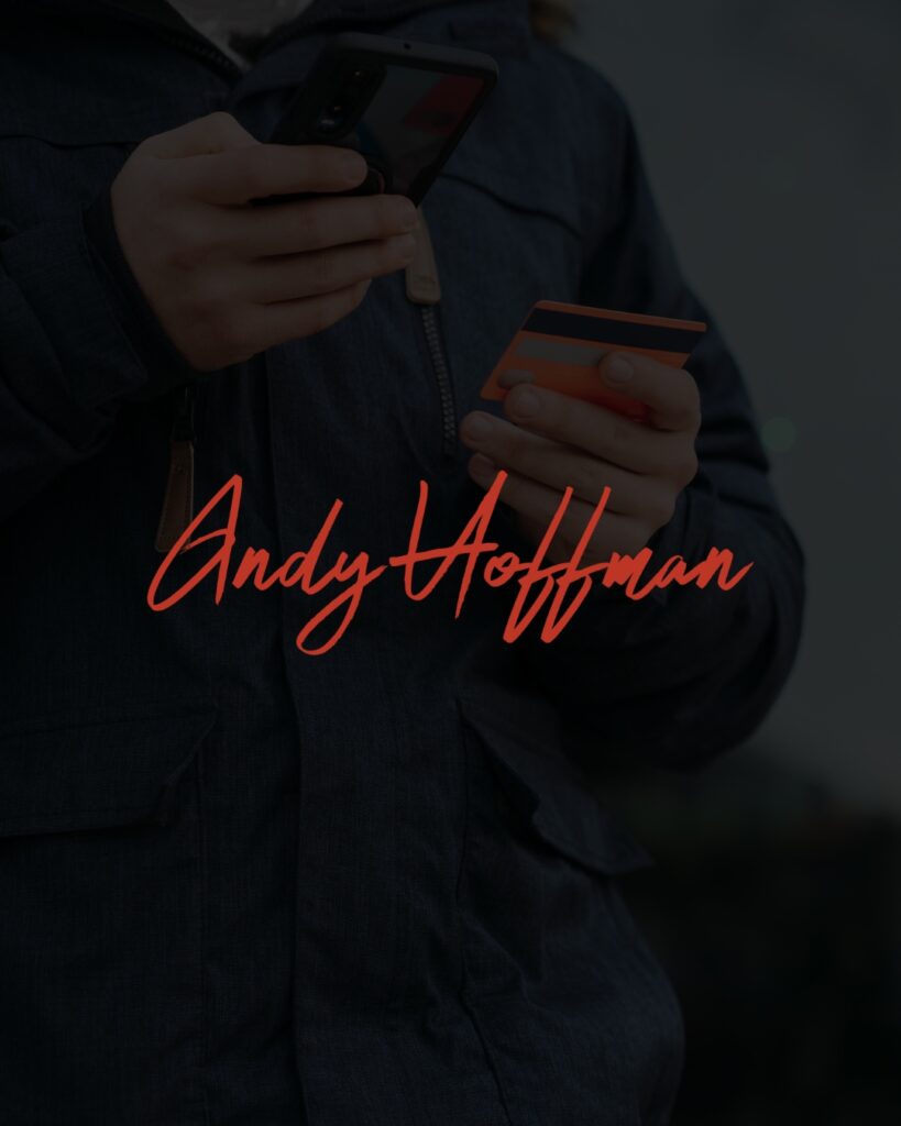 A person holding a phone in one hand and a credit card in another with a black overlay and a signature in the middle for Andy Hoffman. 